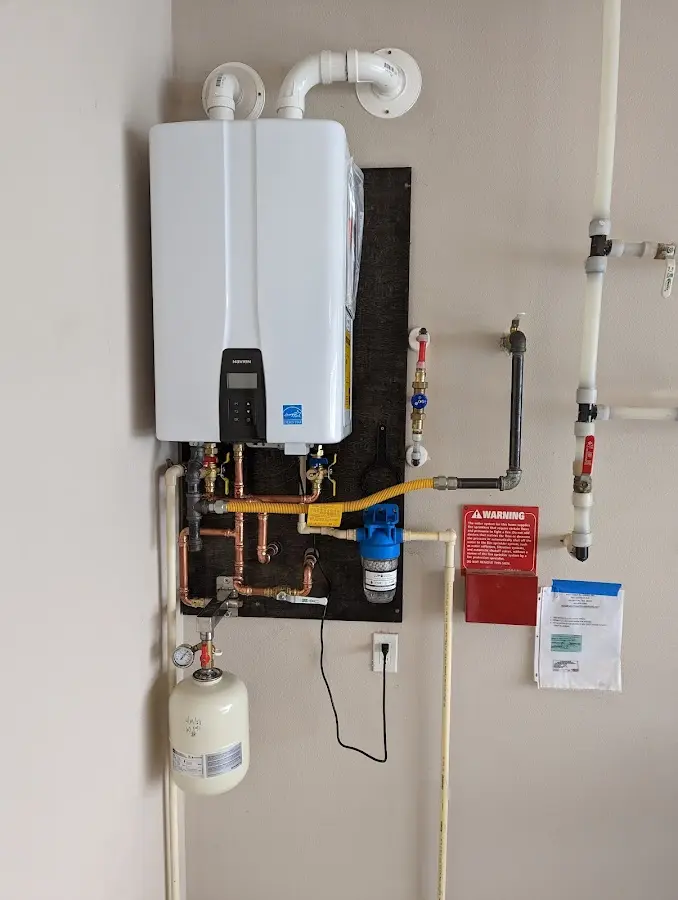 Professional plumber installing copper piping in a Exeter home